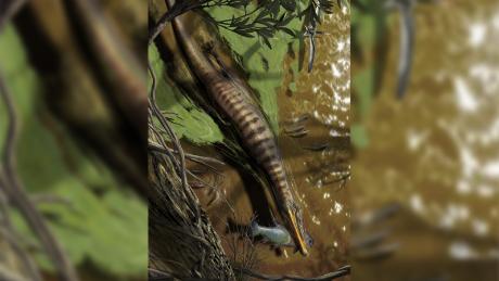 Ilustración de Baryonyx walkeri, un espinosáurido del Reino Unido, cazando y alimentándose.