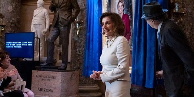 La presidenta de la Cámara de Representantes, Nancy Pelosi, D-Calif., se une a su esposo, Paul Pelosi, mientras asisten a la presentación de su retrato en la Sala de las Estatuas del Capitolio en Washington, el miércoles 14 de diciembre de 2022. 